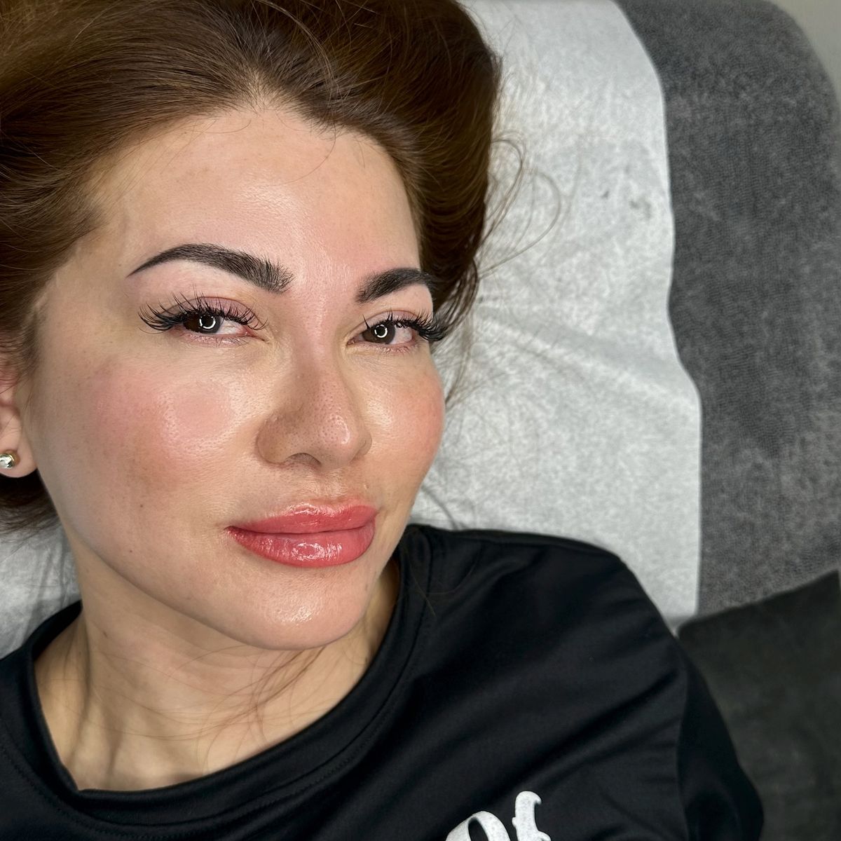 Client showing natural lip color and brows after permanent makeup
